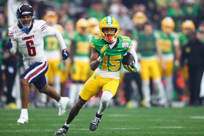 Oregon Ducks wide receiver Tez Johnson (15) runs after a reception against the Liberty Flames during the second quarter of the 2024 Fiesta Bowl at State Farm Stadium.