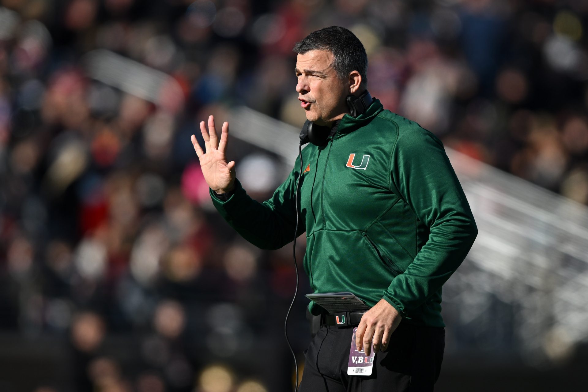 Miami Hurricanes head coach Mario Cristobal calls a play against the Boston College Eagles during the first half at Alumni Stadium.