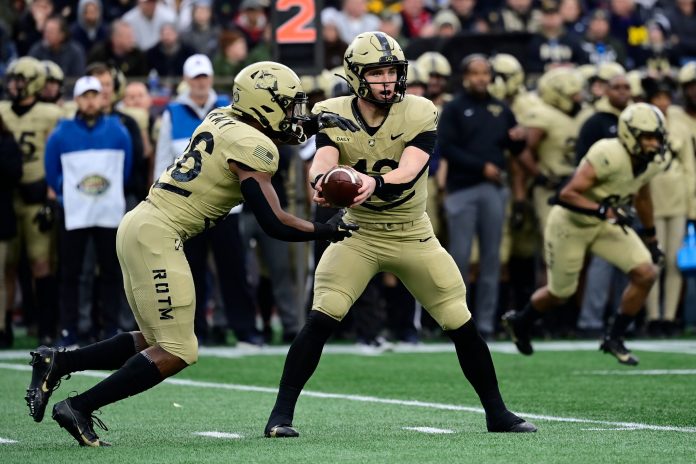 Army Black Knights quarterback Bryson Daily (13) hands the ball off to running back Kanye Udoh (26) during the first half against the Navy Midshipmen at Gillette Stadium.