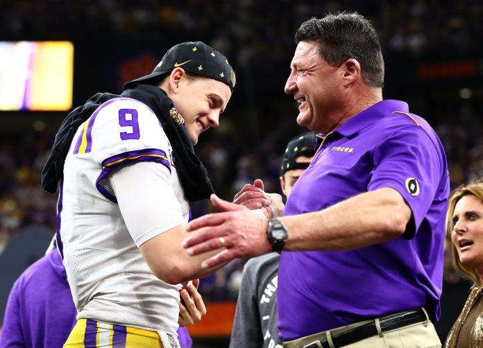 LSU Tigers head coach Ed Orgeron celebrates with quarterback Joe Burrow after a victory against the Clemson Tigers in the College Football Playoff national championship game at Mercedes-Benz Superdome.