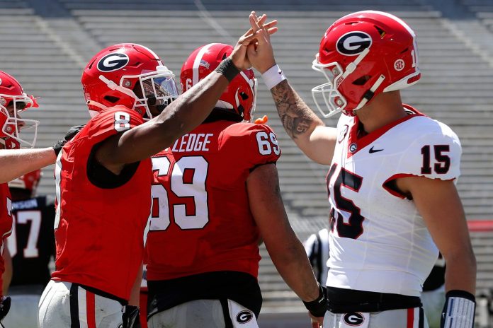 Georgia wide receiver Colbie Young (8) coal celebrates with Georgia quarterback Carson Beck (15) after scoring a touchdown during the G-Day spring football game.