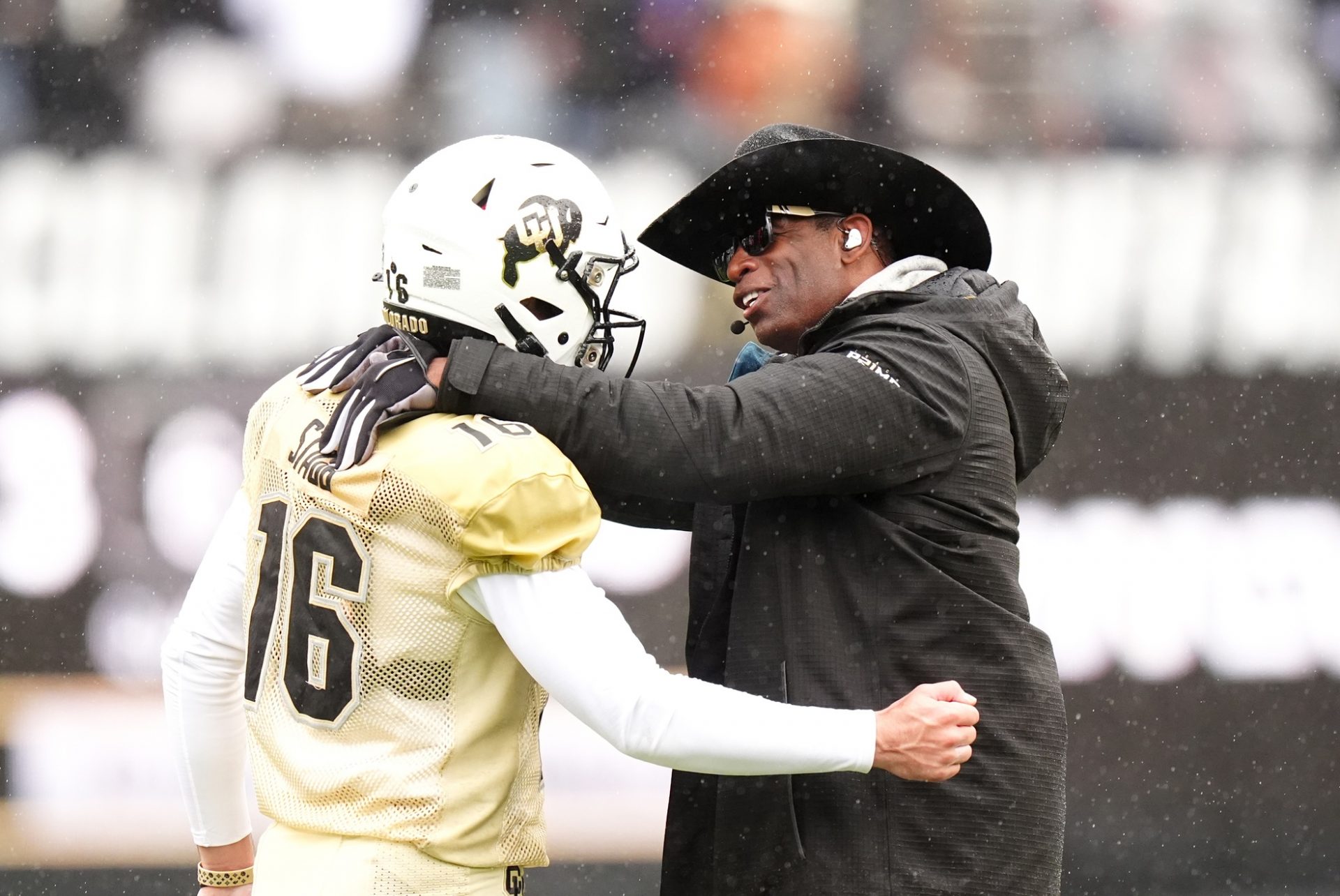 Colorado Buffaloes head coach Deion Sanders talks to quarterback Ryan Staub (16) during a spring game event at Folsom Field.