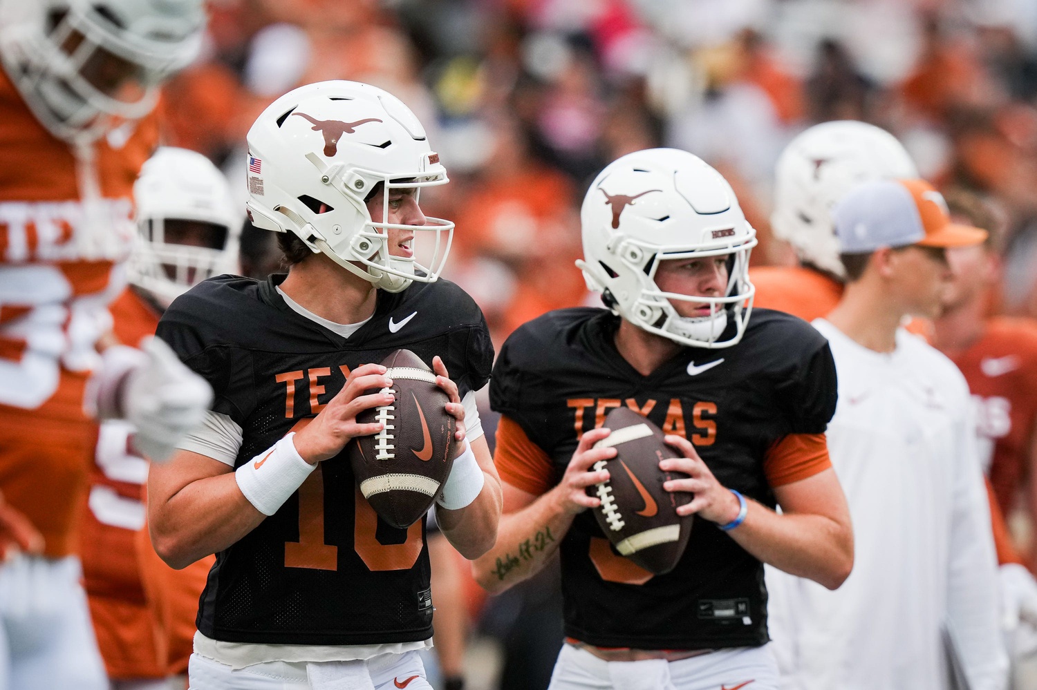 Texas Longhorns quarterbacks Arch Manning (16), left, and Quinn Ewers (3) throw passes while warming up ahead of the Longhorns' spring Orange and White game at Darrell K Royal Texas Memorial Stadium.