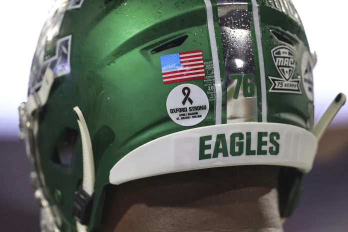 Dec 18, 2021; Mobile, Alabama, USA; Eastern Michigan Eagles offensive lineman Richard Bates Jr. (76) wears a decal on his helmet commemorating the November 30 shooting at Oxford High School during the 2021 LendingTree Bowl game between Eastern Michigan and the Liberty Flames at Hancock Whitney Stadium. Mandatory Credit: Robert McDuffie-USA TODAY Sports