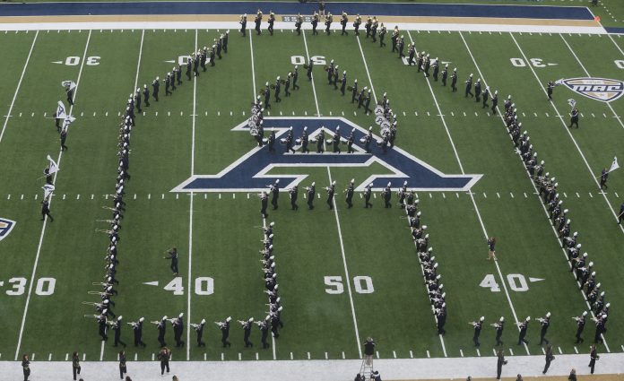 The University of Akron band takes the field before a Zips football game against Ohio on Friday, Nov. 24, 2023.