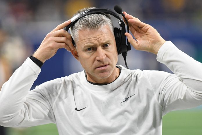 Dec 2, 2023; Detroit, MI, USA; Toledo Rockets head coach Jason Candle puts on his head set before the MAC Championship game against the Miami RedHawks at Ford Field. Mandatory Credit: Lon Horwedel-USA TODAY Sports