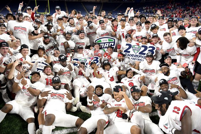 Dec 2, 2023; Detroit, MI, USA; Miami (OH) Redhawks players celebrate on the field after defeating the Toledo Rockets to win the MAC Championship at Ford Field. Mandatory Credit: Lon Horwedel-USA TODAY Sports