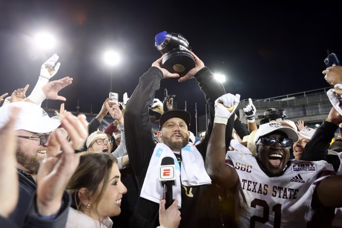 Dec 26, 2023; Dallas, TX, USA; Texas State Bobcats head coach GJ Kinne holds up the trophy after his team defeated the Rice Owls at Gerald J Ford Stadium. Mandatory Credit: Tim Heitman-USA TODAY Sports