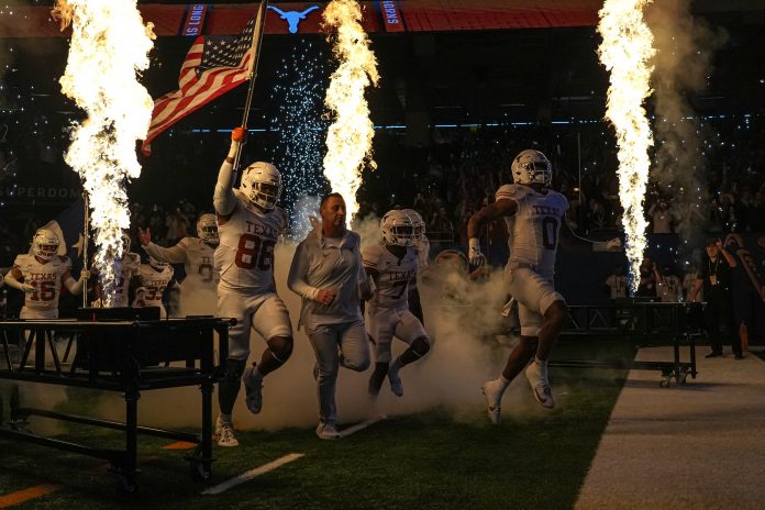 Texas Longhorns head coach Steve Sarkisian leads his team onto the field for the Sugar Bowl College Football Playoff semifinals game against the Washington Huskies at the Caesars Superdome on Monday, Jan. 1, 2024 in New Orleans, Louisiana.