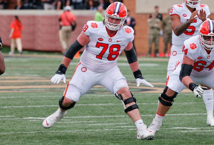 Clemson Tigers offensive lineman Blake Miller (78) and offensive lineman Walker Parks (64) block during the second quarter against the Wake Forest Demon Deacons at Truist Field.