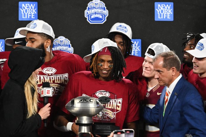Florida State Seminoles running back Lawrance Toafili (9) is awarded the ACC Championship MVP trophy after the game against the Louisville Cardinals at Bank of America Stadium.