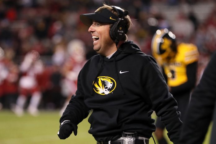 Missouri Tigers head coach Eli Drinkwitz celebrates after a defensive touchdown in the third quarter against the Arkansas Razorbacks at Donald W. Reynolds Razorback Stadium.