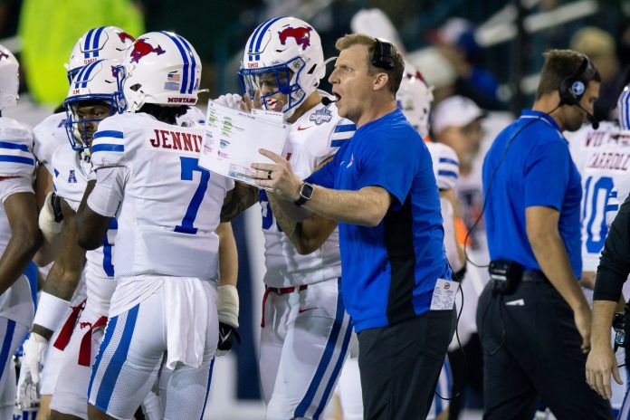 Dec 2, 2023; New Orleans, LA, USA; Southern Methodist Mustangs head coach Rhett Lashlee talks to his players on a time out against the Tulane Green Wave during the second half at Yulman Stadium. Mandatory Credit: Stephen Lew-USA TODAY Sports