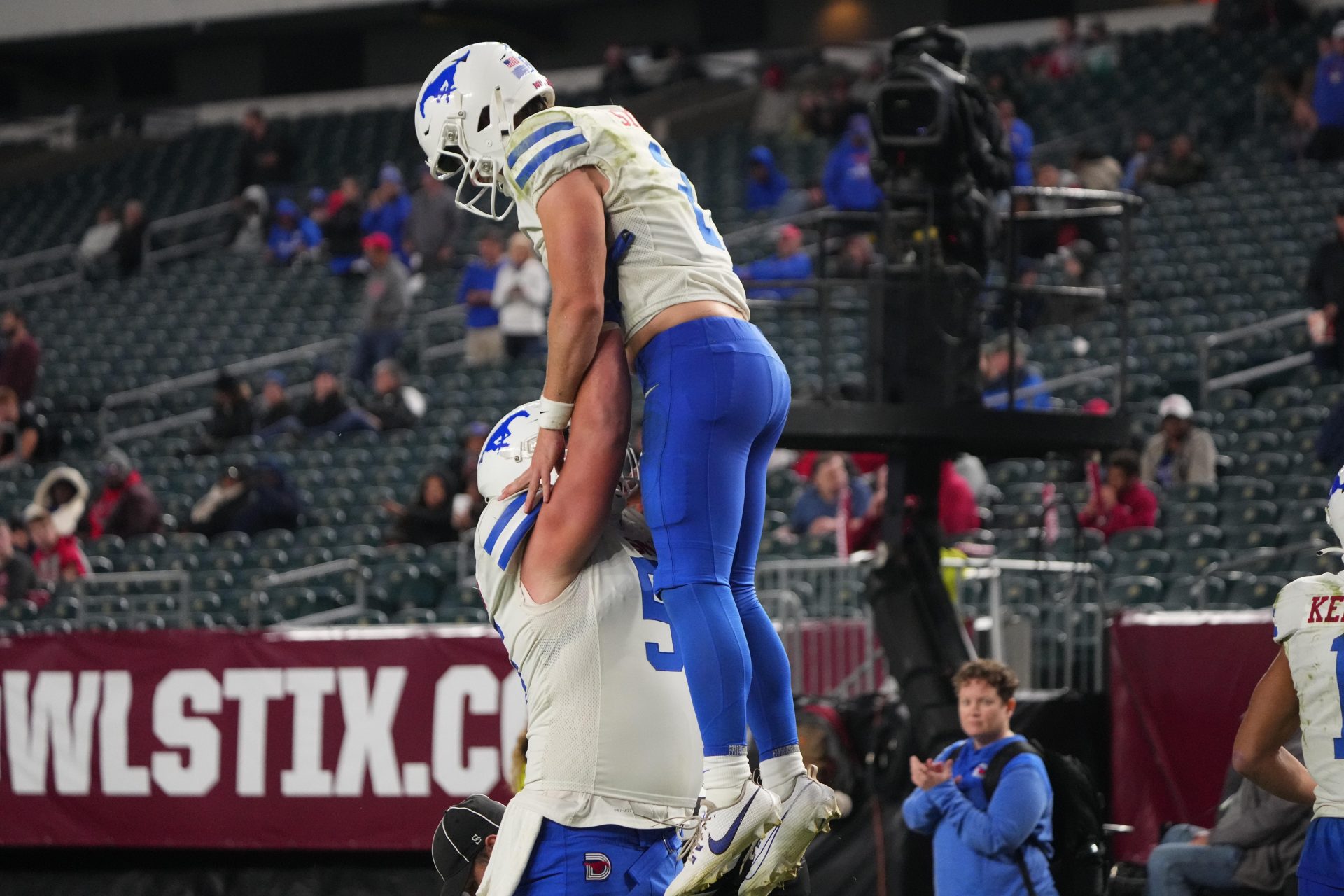 SMU Mustangs wide receiver Moochie Dixon (5) lifts SMU Mustangs quarterback Preston Stone (2) to celebrate his touchdown against the Temple Owls during the second half at Lincoln Financial Field.