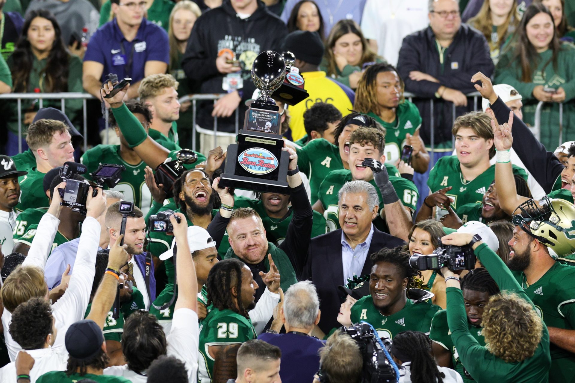 South Florida Bulls head coach Alex Golesh holds up the RoofClaim.com Boca Raton Bowl trophy after beating Syracuse Orange at FAU Stadium.