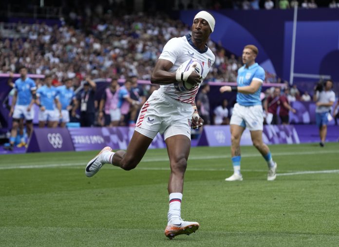 Team United States back Perry Baker (11) scores against Uruguay during the Paris 2024 Olympic Summer Games at Stade de France.