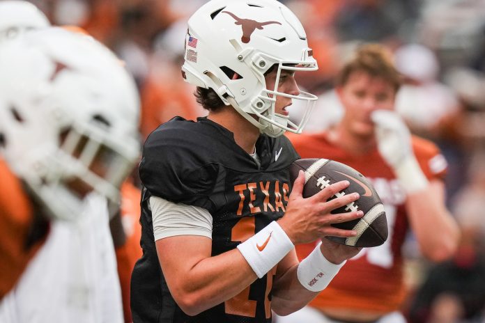 Texas Longhorns quarterback Arch Manning (16) looks for a pass while warming up ahead of the Longhorns' spring Orange and White game at Darrell K Royal Texas Memorial Stadium.