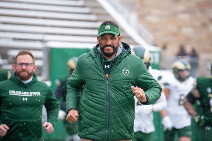 Colorado State University head football coach Jay Norvell runs onto the field before the Green and Gold Spring Game on Saturday.