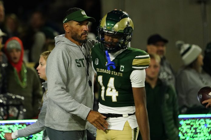 Colorado State Rams head coach Jay Norvell (left) hugs Colorado State Rams wide receiver Tory Horton (14) during pre-game warmups at Sonny Lubick Field at Canvas Stadium.