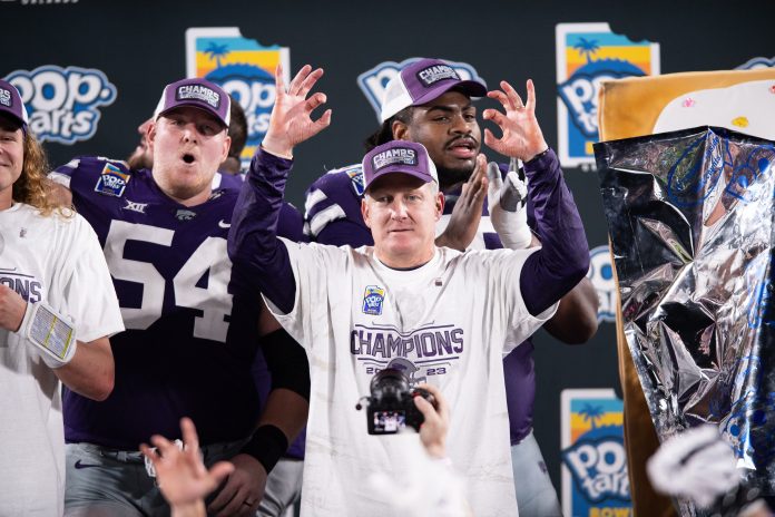 Kansas State head coach Chris Klieman celebrates the victory over NC State after the game at Camping World Stadium.