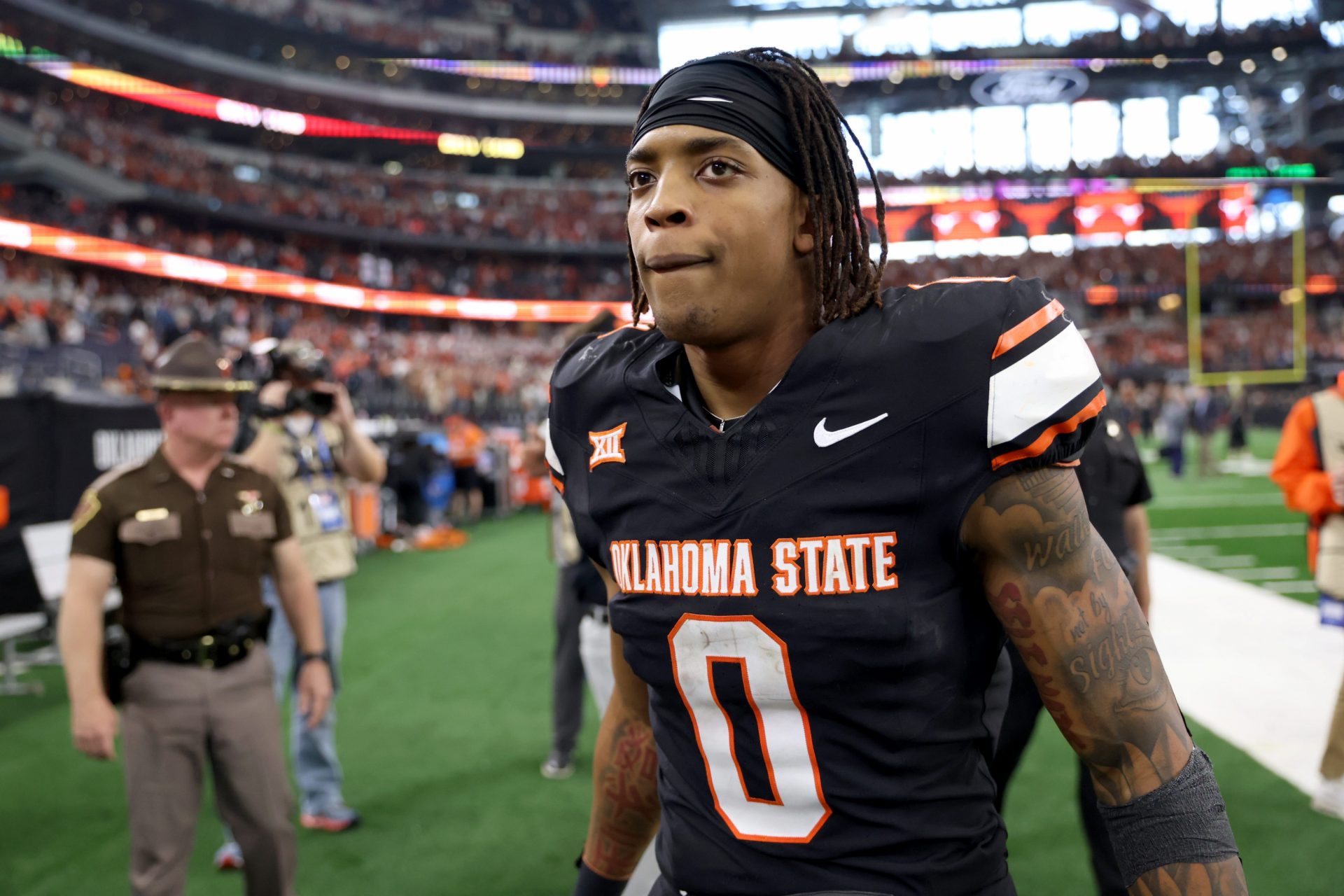 Oklahoma State's Ollie Gordon II (0) walks of the field following the Big 12 Football Championship game between the Oklahoma State University Cowboys and the Texas Longhorns at the AT&T Stadium.