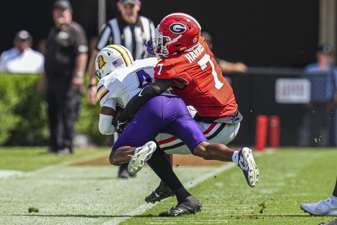 Georgia Bulldogs defensive back Daniel Harris (7) tackles Tennessee Tech Golden Eagles wide receiver Jay Parker (4) during the first half at Sanford Stadium.