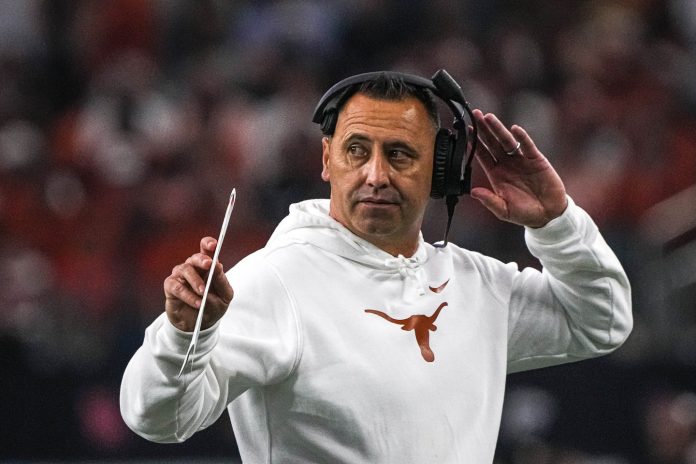 Texas Longhorns head coach Steve Sarkisian walks the sideline during the Big 12 Championship game against the Oklahoma State Cowboys at AT&T stadium.