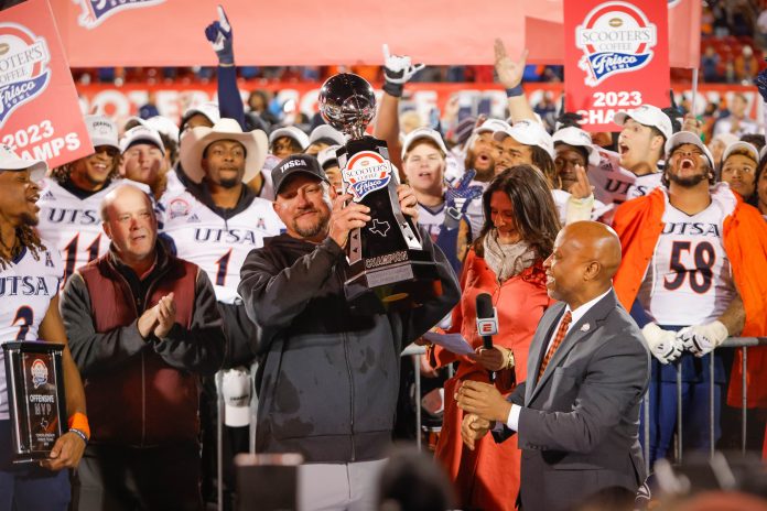 UTSA Roadrunners head coach Jeff Traylor is presented the trophy after winning the Frisco Bowl against the Marshall Thundering Herd at Toyota Stadium.