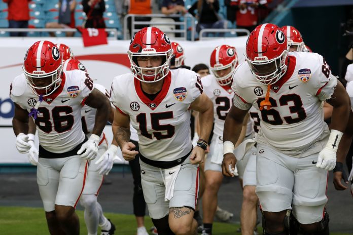 Georgia Bulldogs quarterback Carson Beck (15) leads the team onto the field before the game against the Florida State Seminoles for the 2023 Orange Bowl at Hard Rock Stadium. Georgia is one of the best teams to use in EA Sports College Footbal 25. Mandatory Credit: Sam Navarro-USA TODAY Sports