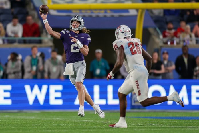 Kansas State Wildcats quarterback Avery Johnson (2) throws a pass guarded by North Carolina State Wolfpack linebacker Devon Betty (26) in the fourth quarter during the Pop-Tarts bowl at Camping World Stadium. Mandatory Credit: Nathan Ray Seebeck-USA TODAY Sports