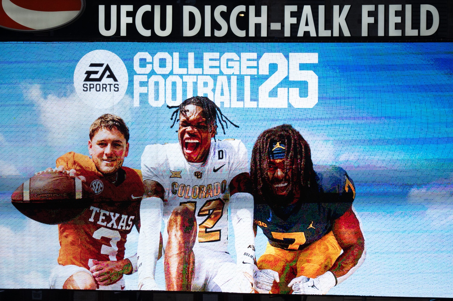 A commercial for the College Football 25 video game, featuring Texas Football quarterback Quinn Ewers plays during the fifth inning of the Longhorns' baseball game against the Kansas Jayhawks, Thursday, May 16, 2024 at UFCU Disch-Falk Field in Austin.