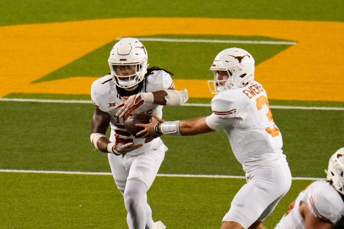 Texas Longhorns quarterback Quinn Ewers (3) hands the ball off to Texas Longhorns running back Jonathon Brooks (24) against the Baylor Bears during the second half at McLane Stadium. Mandatory Credit: Chris Jones-USA TODAY Sports