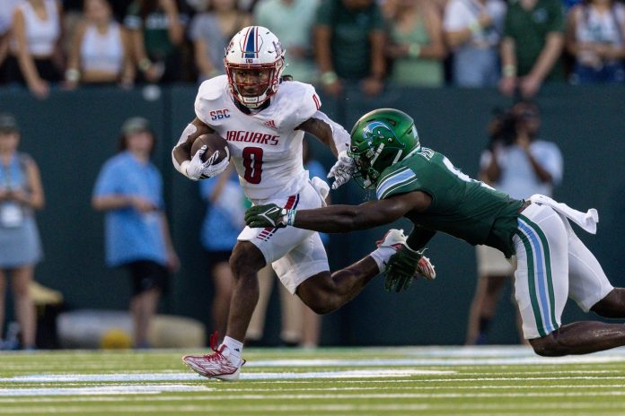 South Alabama Jaguars running back Braylon McReynolds (0) runs the ball against Tulane Green Wave linebacker Corey Platt Jr. (9) during the first half at Yulman Stadium. Mandatory Credit: Stephen Lew-USA TODAY Sports