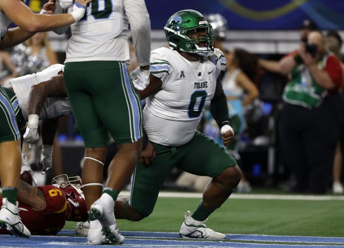 Tulane Green Wave defensive lineman Patrick Jenkins (0) reacts after tackling USC Trojans running back Austin Jones (6) for a safety in the fourth quarter in the 2023 Cotton Bowl at AT&T Stadium.