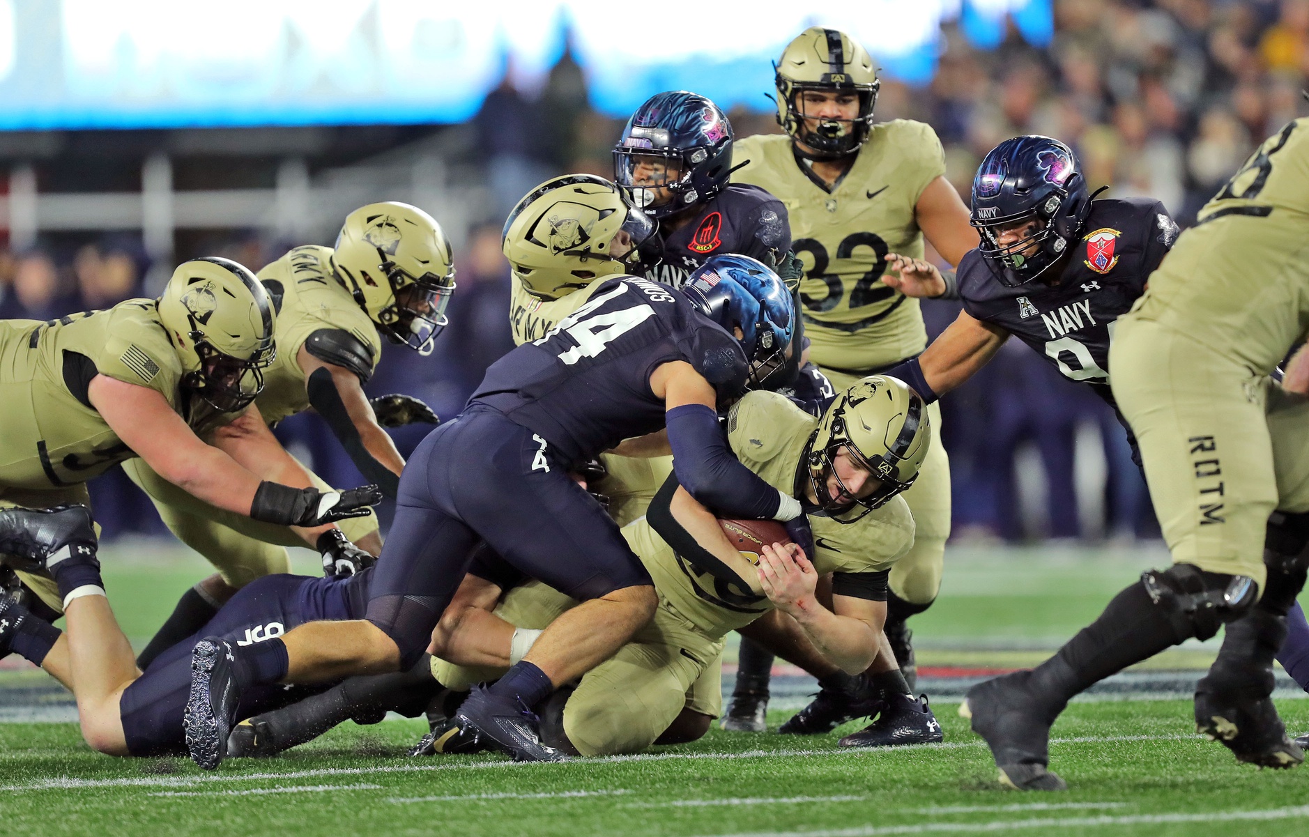 Army Black Knights quarterback Bryson Daily (13) carries the ball as Navy Midshipmen linebacker Colin Ramos (44) tackles him during the second half of the Army-Navy Game at Gillette Stadium.