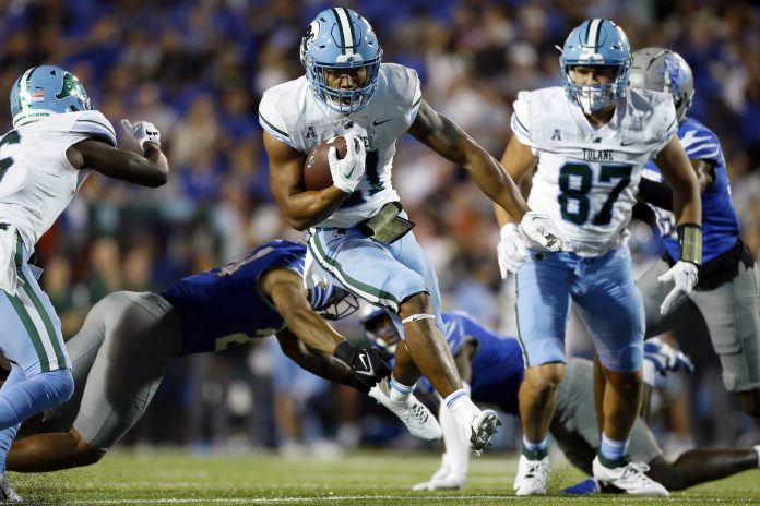 Tulane Green Wave running back Makhi Hughes (21) runs the ball during the second half against the Memphis Tigers at Simmons Bank Liberty Stadium.