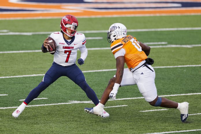 No. 22 Liberty Flames quarterback Kaidon Salter (7) tries to evade a UTEP Miners defensive end Maurice Westmoreland (0) during the first half at Sun Bowl Stadium.