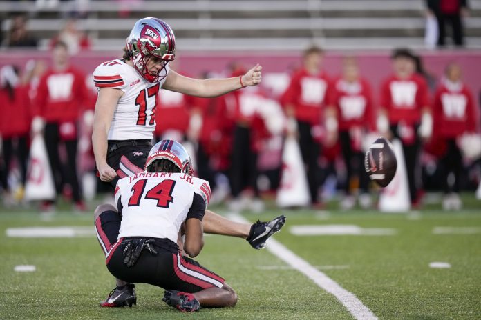 Western Kentucky Hilltoppers place kicker Lucas Carneiro (17) kicks the extra point during the second half against the Old Dominion Monarchs at Charlotte 49ers' Jerry Richardson Stadium.