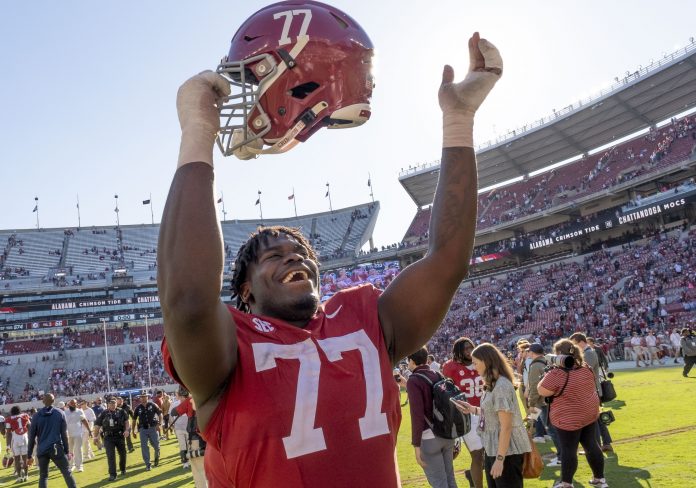 Alabama Crimson Tide offensive lineman Jaeden Roberts (77) celebrates after defeating the Chattanooga Mocs at Bryant-Denny Stadium.