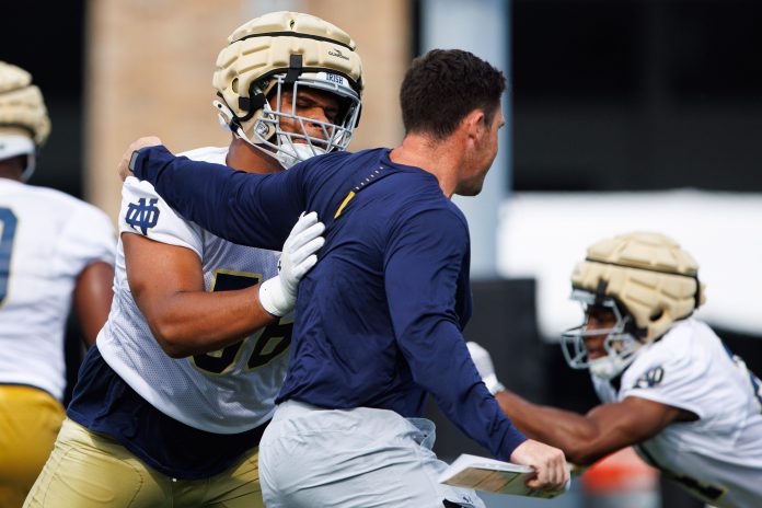 Charles Jagusah (56) participates in a drill during a Notre Dame football practice at Irish Athletic Center.