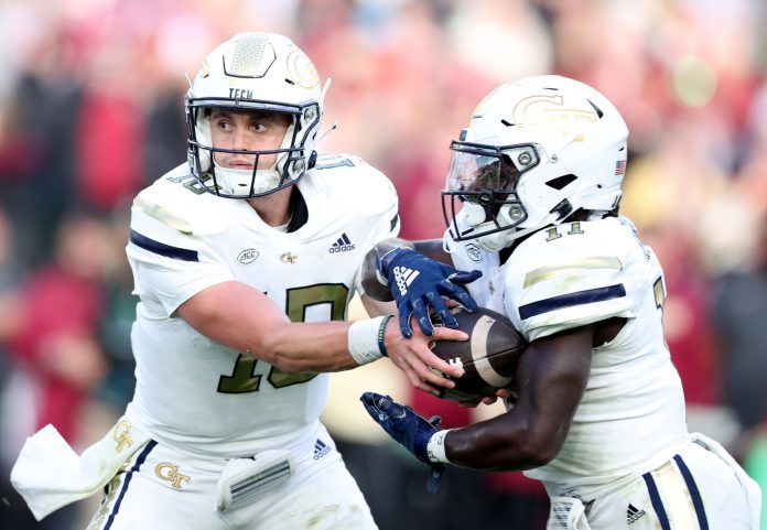 Georgia Tech quarterback Haynes King hands the ball off to Jamal Haynes at Aviva Stadium.