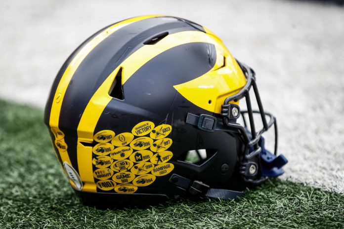 A Michigan football helmet on the field during warmup at the spring game at Michigan Stadium.