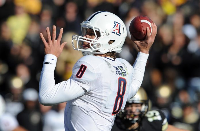 Arizona Wildcats quarterback Nick Foles (8) prepares to throw a pass in second quarter against the Colorado Buffaloes at Folsom Field.