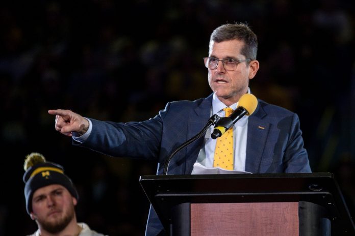 Michigan head coach Jim Harbaugh speaks during the national championship celebration at Crisler Center.