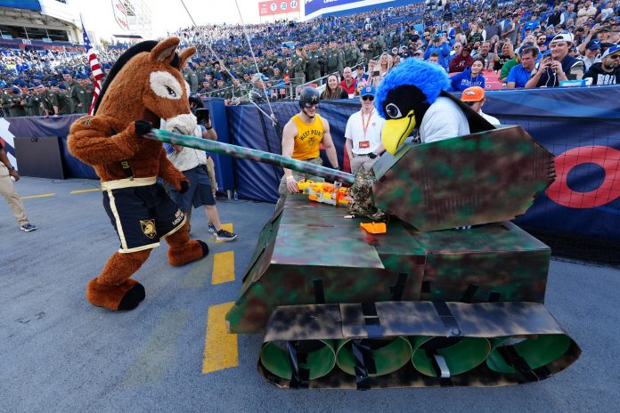 Army Black Knights Mules mascot and Air Force Falcons the Bird mascot perform in the end zone in the first half at Empower Field at Mile High. Mandatory Credit: Ron Chenoy-USA TODAY Sports