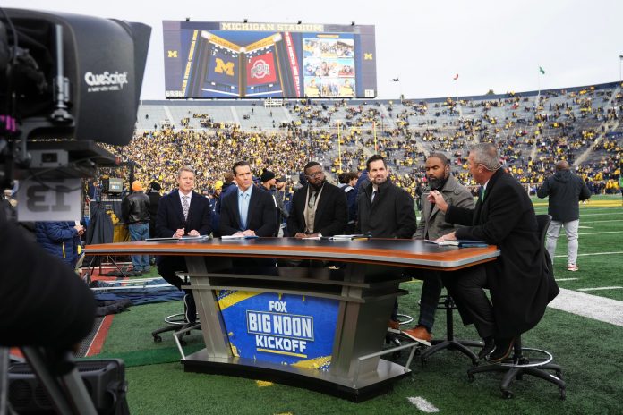 Former Ohio State head coach Urban Meyer talks on the sideline set of Fox Big Noon Kickoff prior to the NCAA football game between the Michigan Wolverines and the Ohio State Buckeyes at Michigan Stadium.