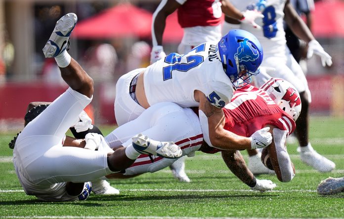 Buffalo safety Marcus Fuqua (10) and linebacker Shaun Dolac (52) take down Wisconsin running back Braelon Allen (0) during the first quarter of the game on Saturday September 2, 2023 at Camp Randall Stadium in Madison, Wis.