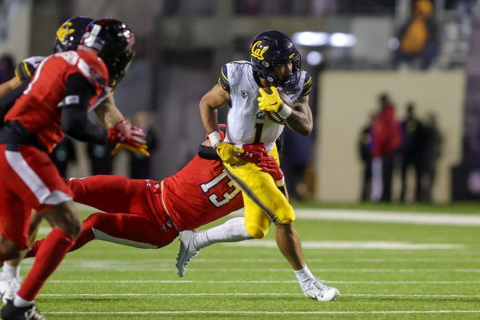 California Bears running back Jaydn Ott (1) shedding a tackle from Texas Tech linebacker Ben Roberts (13) during the 47th Radience Technology Independence Bowl Saturday evening, December 16, 2023, in Shreveport, La.