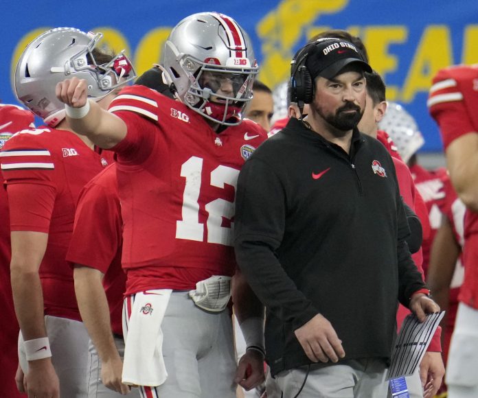 Dec 29, 2023; Arlington, TX, USA; Ohio State Buckeyes quarterback Lincoln Kienholz (12) talks to Ohio State Buckeyes head coach Ryan Day in the third quarter against Missouri Tigers during the Goodyear Cotton Bowl Classic at AT&T Stadium. Mandatory Credit: Kyle Robertson-USA TODAY Sports