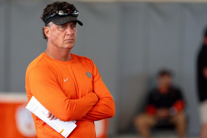 Head coach Mike Gundy walks on the field during an Oklahoma State football practice in Stillwater, Okla., on Saturday, Aug. 3, 2024.